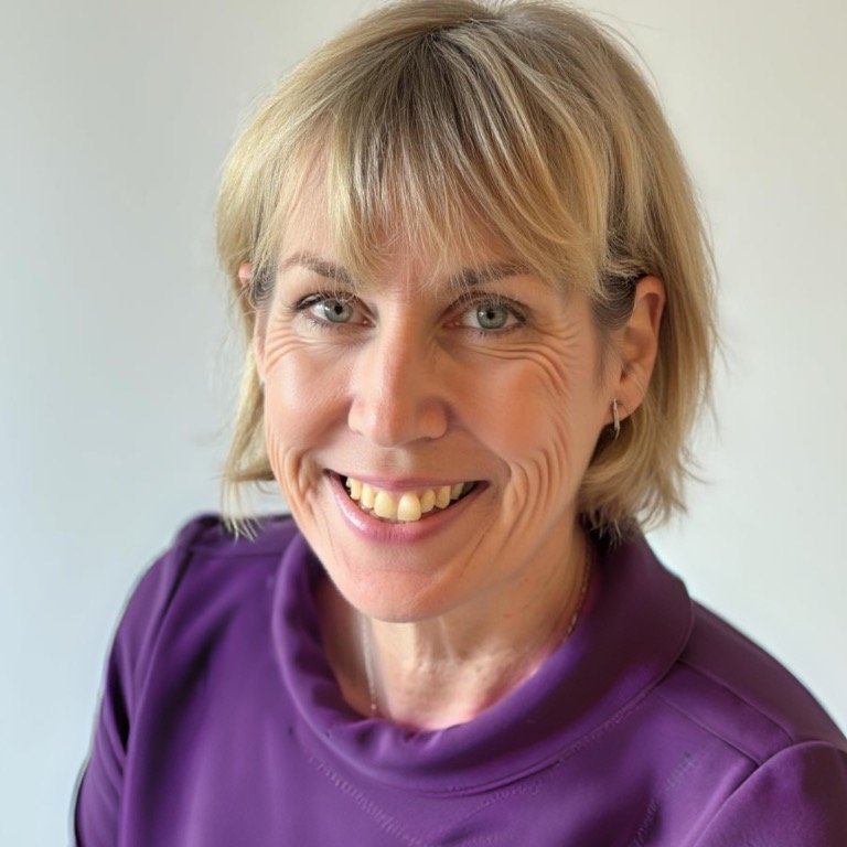 purple jumper woman in purple jumper smiling